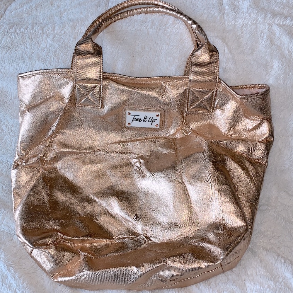 NWOT Tone It Up Rose-gold Carryall bag.  Large, super cute lining, zipper pocket